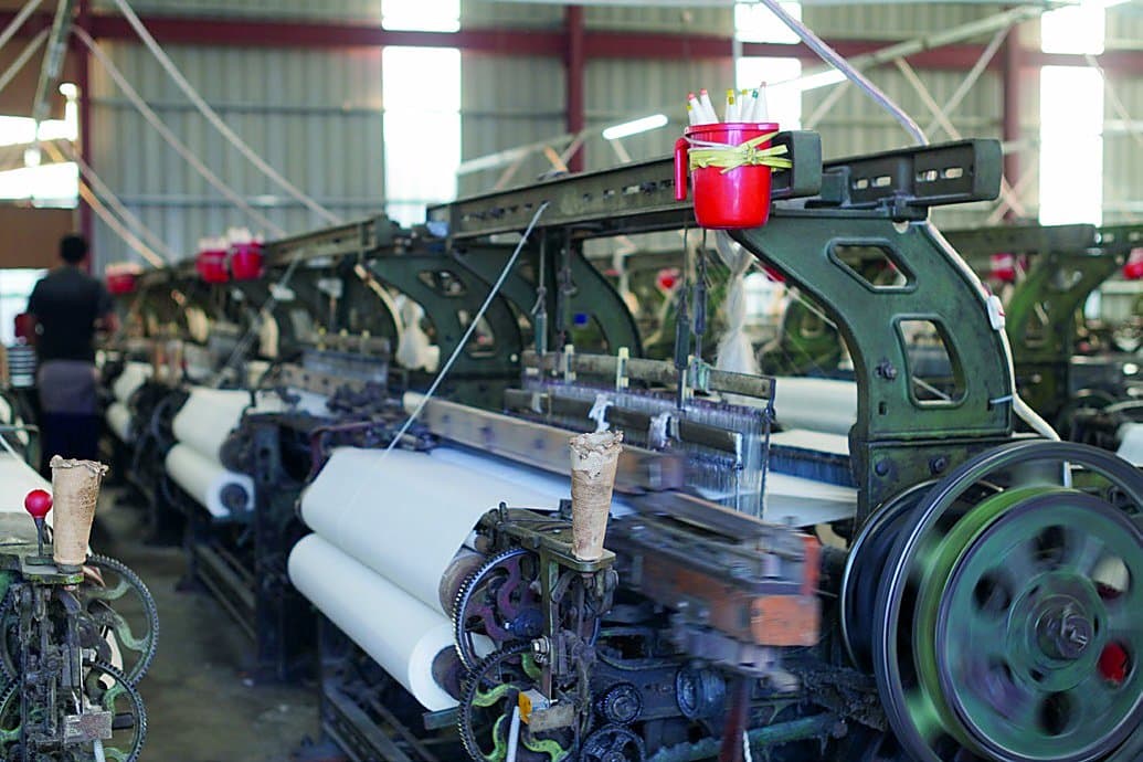 Power looms in operation