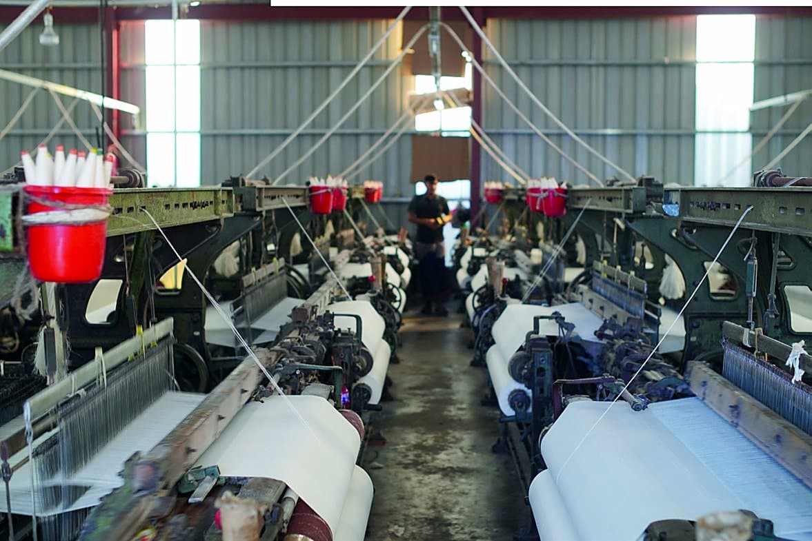 Rows of power looms at the Dream Textiles factory