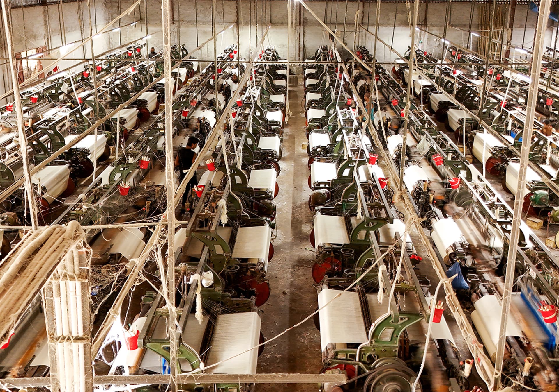 Rows of power looms at the Dream Textiles factory